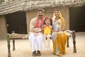 Rural Indian family holding dream house model Royalty Free Stock Photo