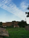 Rural landscape with abandoned wooden house, sky and meadow Royalty Free Stock Photo