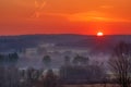 Rural landscape against a beautiful orange sunset sky in Venango, Pennsylvania