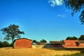 Rural landscape with arable fields and farm buildings in summer Royalty Free Stock Photo