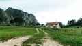 Rural landscape with country house of local farm past the green mountain forests.A scenic road through the traditional village in