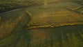 Rural landscape at dawn. Green forests and fields in the rays of the rising sun. Aerial photography Royalty Free Stock Photo