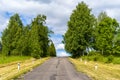 Empty asphalt road goes up, greenery on the sides of the road Royalty Free Stock Photo