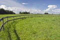 Rural landscape farmland field with wooden fence