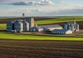 A rural landscape featuring a grain storage facility with multiple Royalty Free Stock Photo