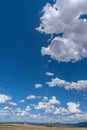 Rural landscape of fields, hills and stunning skyscape with cumulus clouds Royalty Free Stock Photo