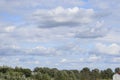 Rural landscape with fields trees and houses under cloudy sky Royalty Free Stock Photo