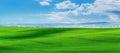 Rural landscape with green field and blue sky with white clouds Royalty Free Stock Photo