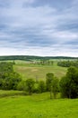 Rural landscape. Hilly terrain. Forest fields and cloudy skies with clouds.