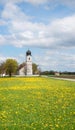 rural landscape Hohenkirchen, church St Leonhard, dandelion meadow Royalty Free Stock Photo