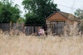 Rural landscape with a house and small children