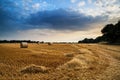 Rural landscape image of Summer sunset over field of hay bales Royalty Free Stock Photo