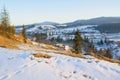 Rural landscape last snow in village in mountains in sunny evening Royalty Free Stock Photo