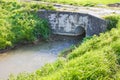 Rural landscape with masonry bridge and ditch water Royalty Free Stock Photo