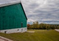 Rural landscape - old farm, green barn, field and garden, cloudy sky Royalty Free Stock Photo