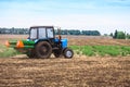 Rural landscape with old tractor in a field sow seed. Royalty Free Stock Photo