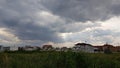 Rural landscape with overcast sky and sun rays shining Royalty Free Stock Photo