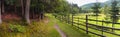 Rural landscape, panorama, banner, with a wooden fence along the trail near the village of Kolochava