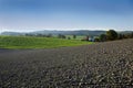 Rural landscape, freshly ploughed field under the blue cloudless sky of Austria Royalty Free Stock Photo