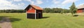 Rural landscape with a red shack and a barn in central Sweden Royalty Free Stock Photo