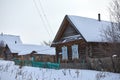 Rural landscape of Russia. Winter village with a house and forest Royalty Free Stock Photo