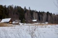 Rural landscape of Russia. Winter village with a house and forest Royalty Free Stock Photo