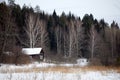 Rural landscape of Russia. Winter village with a house and forest Royalty Free Stock Photo