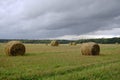 Rural landscape scene. Open spaces. Harvested field and stubble. Bales of collected straw. Royalty Free Stock Photo