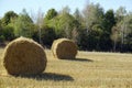 Rural landscape scene. Open spaces. Harvested field and stubble. Bales of collected straw Royalty Free Stock Photo
