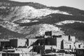 Rural landscape with a small cluster of houses nestled in a lush green valley, New Mexico Pueblo