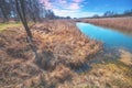 Rural landscape in spring. Narrow river on a sunny day