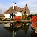 Rural landscape. Thatched roof house in autumn. Cottage in rustic style in leaf fall. Tourism in countryside. Dnipro, Ukraine Royalty Free Stock Photo