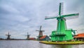 Rural landscape - view of the windmills on a cloudy winter day at the Zaanse Schan in the neighbourhood of Zaandam town Royalty Free Stock Photo