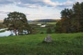 Rural landscape with views of the windmill river and fields with a cross in the foreground. Pushkin Hills with Savkina Gorka.