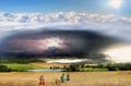 Thundercloud, lightning and rain above the pond and wheat fields