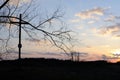 Rural landscape with willow trees and cross near a river in early spring during sunset in the evening before dusk Royalty Free Stock Photo