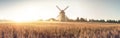 Rural landscape with windmill and village Royalty Free Stock Photo