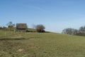 Rural landscape with a wooden house on a hillside in spring Royalty Free Stock Photo