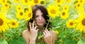 Rural landscape with young beautiful sexy brunette woman, in a field of yellow sunflowers Royalty Free Stock Photo