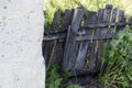 Rural life, old wooden skewed collapsing fence protects the private territory