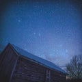 Rural Log Cabin barn at night with stars and milky way Royalty Free Stock Photo