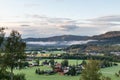 Rural Norway countryside morning sunrise view. Nice small nordic houses, green grass fields Royalty Free Stock Photo