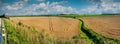 Panoramic landscape of wheat fields ready for harvest and irrigation canal. Top view