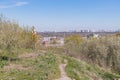 A rural path leads through a maintained park or nature reserve, passing under taller trees and ending with an open space In the Royalty Free Stock Photo
