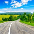 Rural paved road among fields