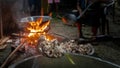 Rural people cooking large meals with wood and basic pottery