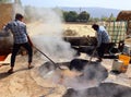 Man working in a factory boiling sugar cane.