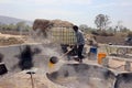 Man working in a factory boiling sugar cane.