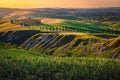 Rural road and agricultural lands at sunset, Tuscany, Italy Royalty Free Stock Photo