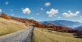 Rural road and autumn mountain landscape Royalty Free Stock Photo
